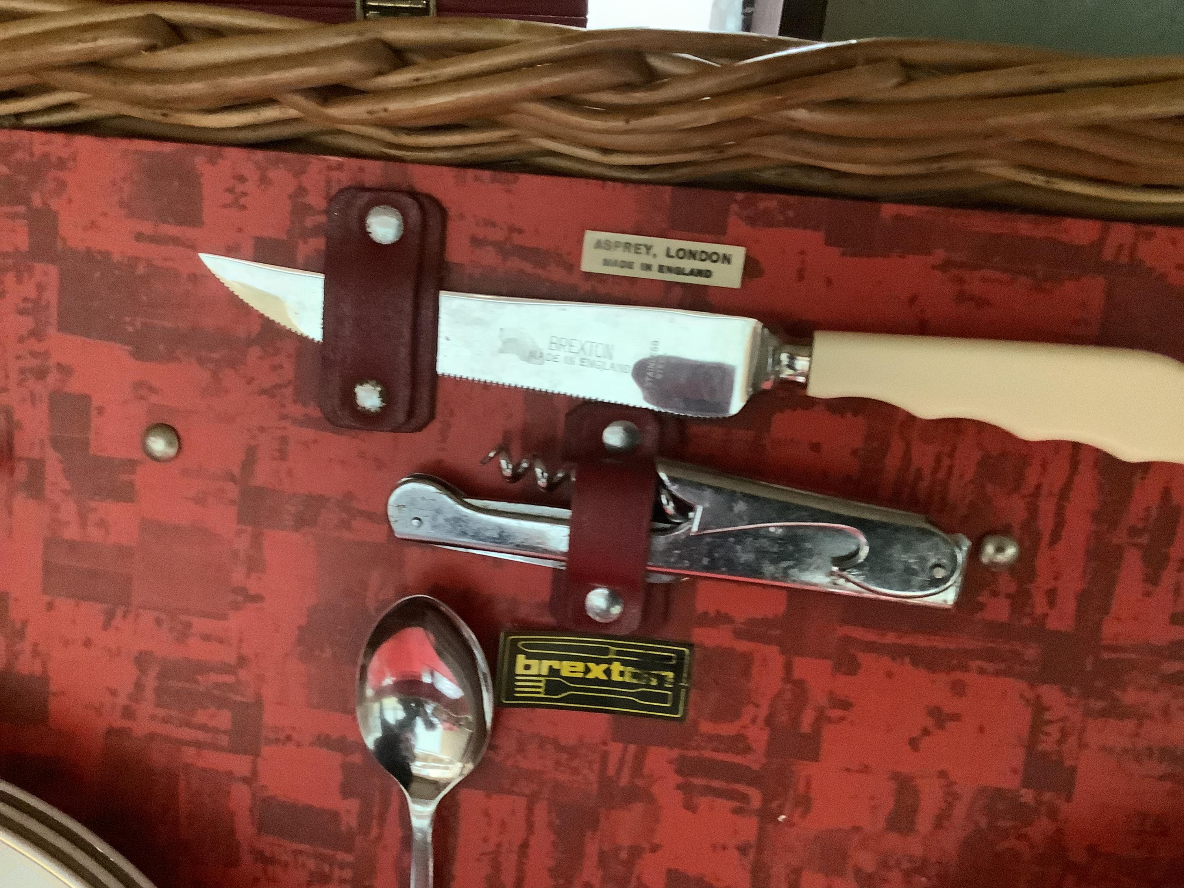 An Asprey wicker picnic basket, fully fitted with contents